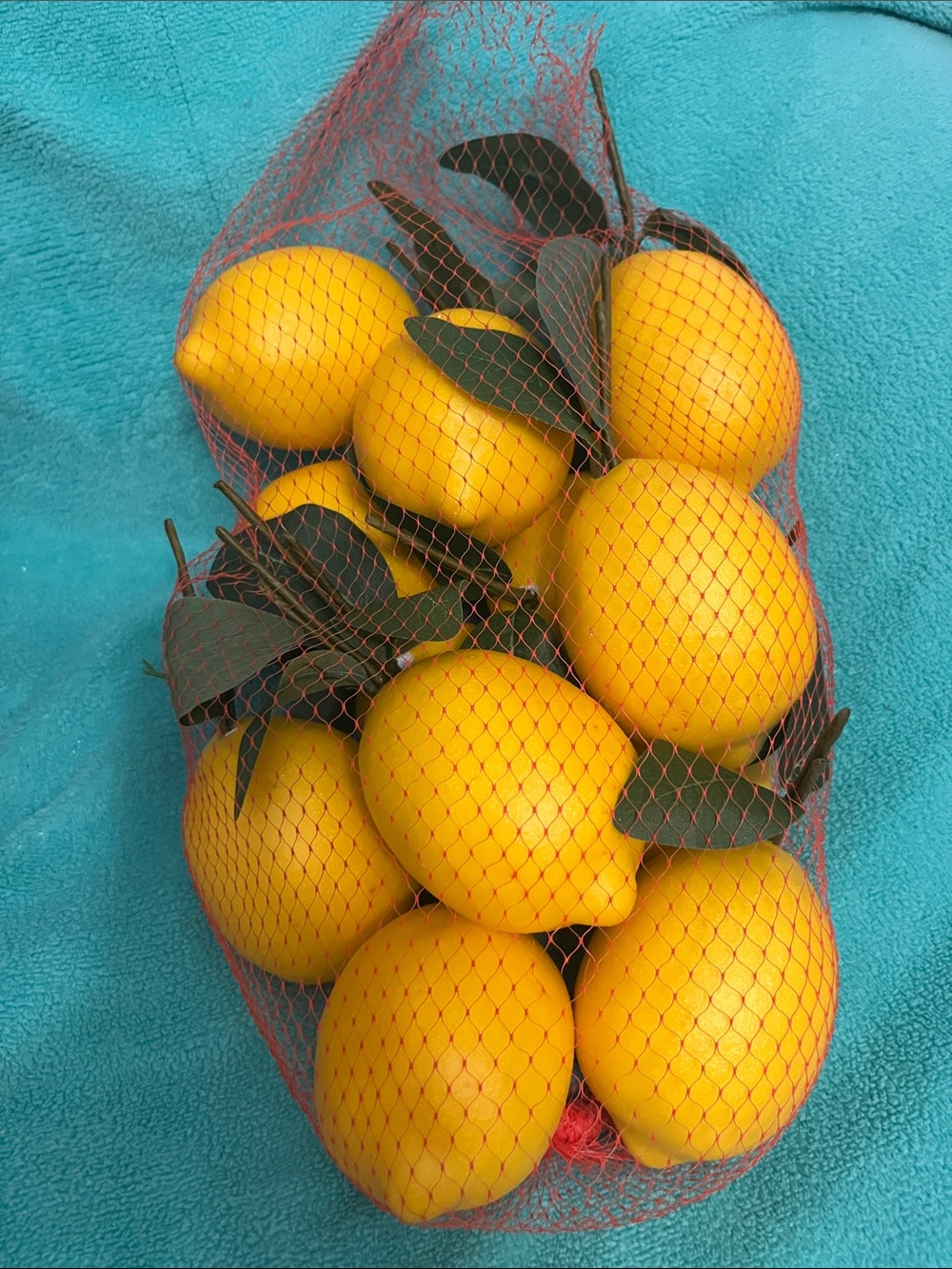 Kirklands Yellow Faux Lemons with Green Leaves in Red Mesh Bag